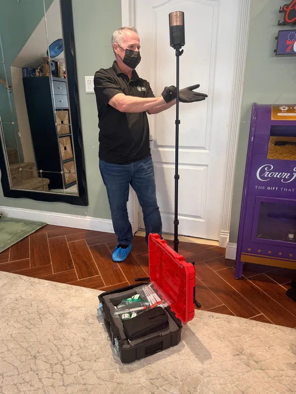 Mold inspector in a mask and gloves during an indoor air quality test in Philadelphia