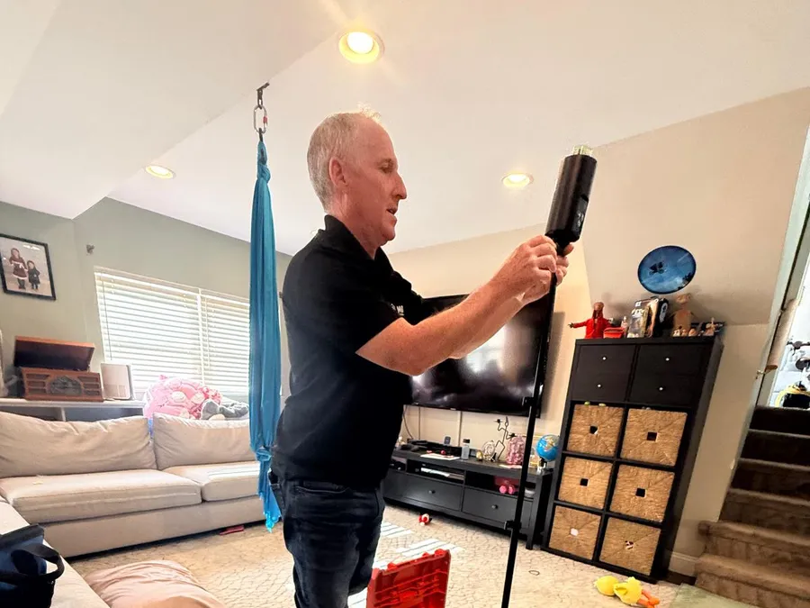 Inspector setting up an air sampling pump for a mold test in a Philadelphia home